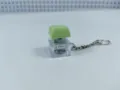 Close-up detail of the transparent mechanical keyboard keycap keychain with electronic light. - 009