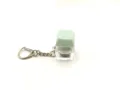 Macro detail of mint green mechanical keycap fidget toy keychain with transparent base - [with light] light green
