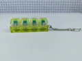 Detailed view of a 4-key transparent yellow LED mechanical switch tester keychain - 4-Key Style / With Lights / Fluorescent Green