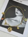 Detailed macro view of vintage gold chain necklace with sun moon and floral charms - Moon Face Style