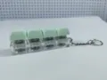 Close-up detail of the 4-key mechanical keyboard switch keychain with light-up green keycaps. - Four-Key Thick Cover Ordinary Chain / No Light / Light Green