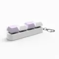 Detail view of 4-key mechanical switch keychain with purple and white caps on white base. - Size Seven / 4 Keys Without Light