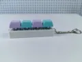 Detail of 4-key mechanical keyboard switch keychain in purple and blue colors. - Size Nine / 4 Keys Without Light
