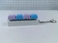 Detail view of mechanical switch fidget keychain with colorful purple and blue keycaps - Size Eight / 4 Keys Without Light