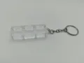 Detailed macro view of a 3-slot transparent mechanical switch tester keychain base - Triple Key Base With Ring Chain / High Transparency