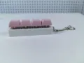Close-up view of a pink 4-key mechanical keyboard switch fidget toy keychain for stress relief - Style 15 / 4 Keys Without Light