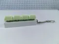 Detailed side view of a 4-key mechanical keyboard switch keychain with green keycaps - Style 20 / 4 Keys Without Light