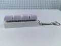 Close-up of four mechanical keyboard switches with purple keycaps on a white keychain base. - Purple Style (Model 22) / 4 Keys Without Light