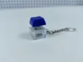 Detailed view of the clear blue mechanical keyboard switch keychain toy with LED glowing light. - 020