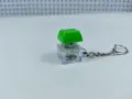 Mechanical keyboard switch keychain fidget toy with green keycap and glowing light inside. - 024