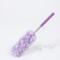 Extendable microfiber duster with purple handle for household cleaning and dust removal. - Purple White