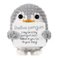 Detail van een gehaakte grijze pinguïnpop die een positieve boodschapskaart vasthoudt - Grijze Pinguïn (Positieve Kaart) / Grijs