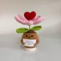 Detailed view of a handmade crocheted potted flower with a positive encouragement card - Blooming Red Heart Tulip