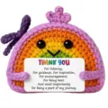 Handmade crochet rainbow plush toy detail view showing cute facial expression and thank you card. - Thank You Rainbow Doll