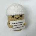 Detailed close-up shot of a cute handmade crochet coffee plush doll holding funny quote card. - Coffee Cup