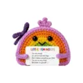 Closeup detail of a cute handmade crochet rainbow doll holding a motivational card toy. - Little Rainbow Doll