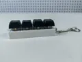 Close-up of a 4-key mechanical keyboard switch fidget toy keychain in black and white. - Style 18 / 4 Keys Without Light