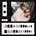 Detail of cow and zebra print press-on nails set with 24 pieces in black and white - R170 Black Stripes / Glue Type