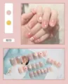 Detail view of 24-piece pink press-on nail set featuring white flower and dot designs - Nude Pink Floral (R010) / 24Pcs Set (Glue Style)