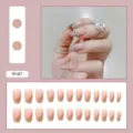 Detailed close-up of nude pink press-on nails featuring gold glitter diagonal French tips. - R187 Diagonal Glitter Style / Glue Type