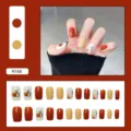 Detail view of orange and beige press-on nails set with cute fruit pattern designs - R188 Orange Graffiti / Glue Type
