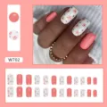Vista dettagliata di unghie finte rosa corallo a fiori con layout del set da 24 pezzi - Stile Quadrato Floreale Rosa Dolce (W702)
