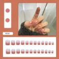 Detailed view of peach gradient press-on nails featuring delicate white heart patterns - R191 Girlish Heart Pattern / Glue Type