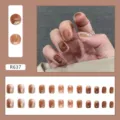 Macro detail of 24pcs amber brown marble press-on nails with gold foil accents - Ice Caramel (R637)