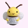 Handmade crochet bee doll holding a positive message card for stress relief - Bee No.2