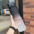 Detail of 1000ml frosted gradient sports water bottle with black wrist strap - 500ml / Black and White Gradient