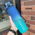 Blue-green gradient 1000ml sports water bottle held by hand in outdoor setting - 500ml / Blue Green Gradient