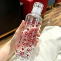 Detailed view of clear plastic cup with red bow and heart patterns for students. - 500ml / Red Bow