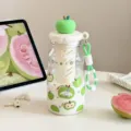 Detailed view of a cute green apple themed plastic water bottle with tea infuser and lanyard. - 8015 Green Apple Lid