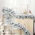 Detailed view of white snow-flocked Christmas garland draped on home furniture - 180cm / Christmas Flocked Garland