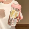 Close-up of portable pink plastic water bottle with tea infuser and carry strap. - Third Gen Tea Filter Cup / 600ml / Pink