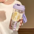 Close-up of a purple portable plastic water bottle with lemon infuser and carry strap. - Third Gen Tea Filter Cup / 600ml / Purple