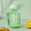 Portable plastic water bottle with straw and infuser, clear scale and carrying strap. - Tea Green