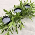 Detailed view of an olive branch candle holder with black iron plates for table decor - Olive Branch Candle Holder