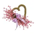 Close-up of pink artificial heart-shaped wreath with lavender bow for home decor - Pink