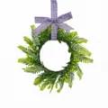 Detail view of artificial Persian fern wreath with purple checkered bow on white background - Purple Plaid Bow Style