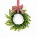 Decorative artificial Persian leaf wreath featuring a classic red and white checkered bow. - Red White Plaid Bow