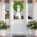 Elegant artificial green boxwood wreath with white ribbon bow on a white front door - Boxwood Wreath (With White Sash) / 50cm