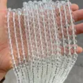 Close-up macro view of clear synthetic white crystal round beads for DIY jewelry - 10mm (Approx 37 Beads) / Clear