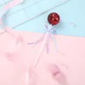 Red sequin lollipop cake topper detail, cute party dessert decoration insert close up view. - Red