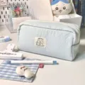 Close-up detail of cute light blue canvas pencil pouch with sweet cat graphic label and zipper. - Cat and Dog Patch / Blue