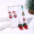 Close-up of Christmas earring set with Santa studs and red bell hook earrings - Active Santa Claus Style (9#)
