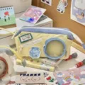 Detail view of canvas pencil case with clear round window and cute milk patch on desk. - Happy Milk Pencil Case