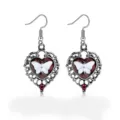 Detailed macro view of vintage silver heart-shaped earrings with white butterfly motif - Heart Butterfly