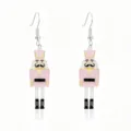 Detailed view of pink nutcracker soldier earrings with glitter finish for Christmas. - Pink Nutcracker