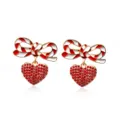 Close-up of Christmas bowknot earrings with red striped enamel and crystal heart - Bow Red Heart